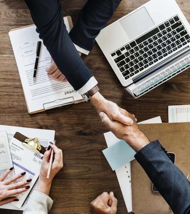 Business people shaking hands together